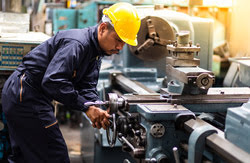 Man operating industrial machine