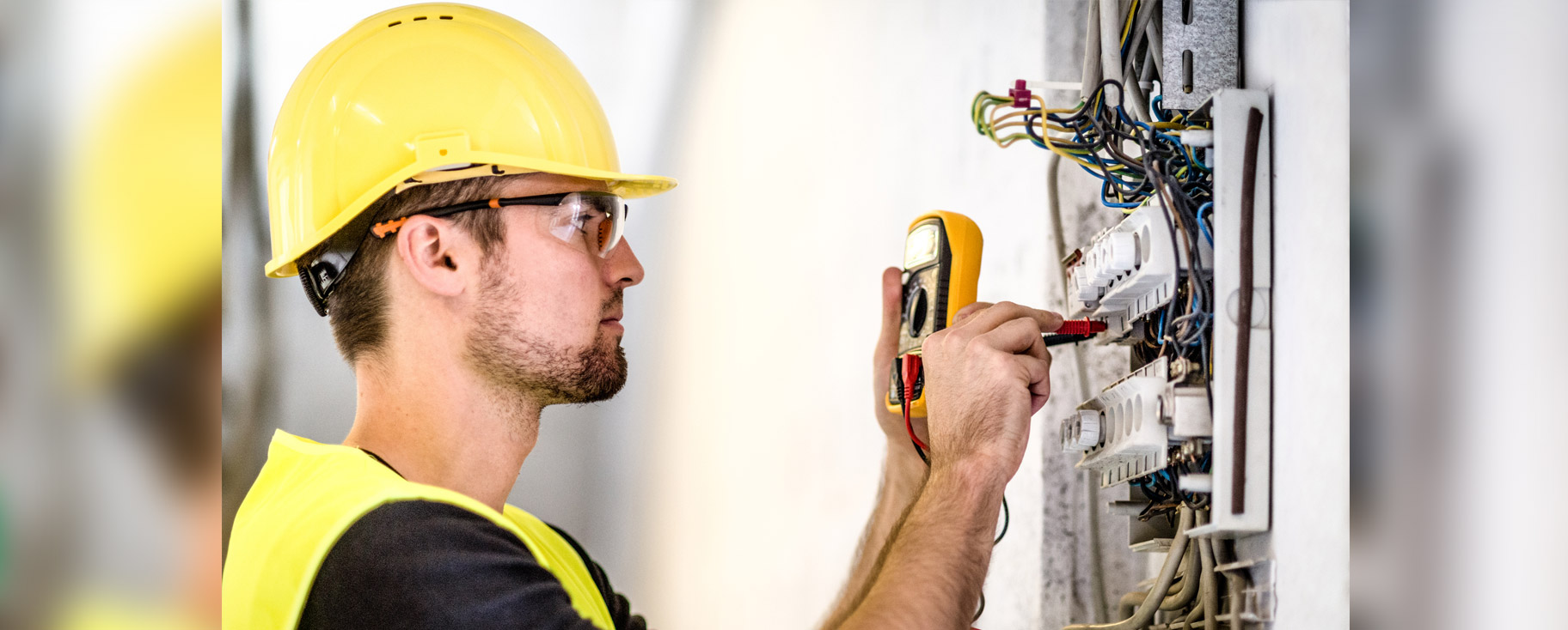 electrician working on electrical panel