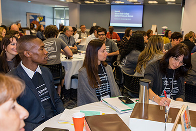 Students and faculty in a conference room