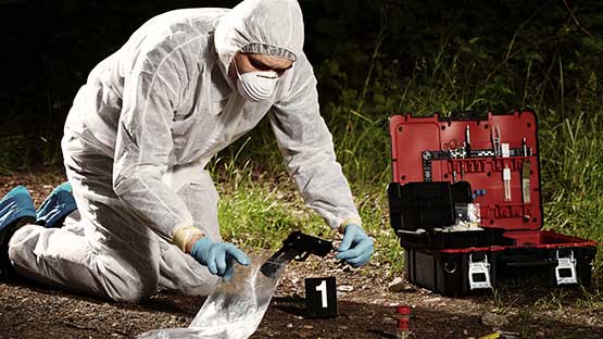 Crime Scene technologist adquiring evidence
