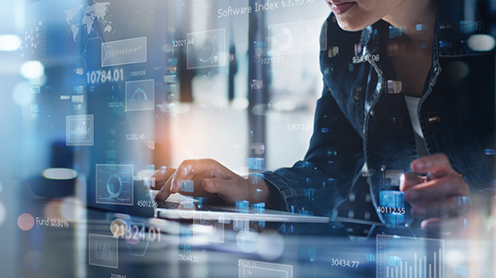 A person on a computer with intelligence and national graphics on the screen.
 