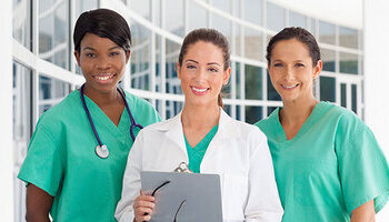 Three licensed practical nurses wearing lab coats